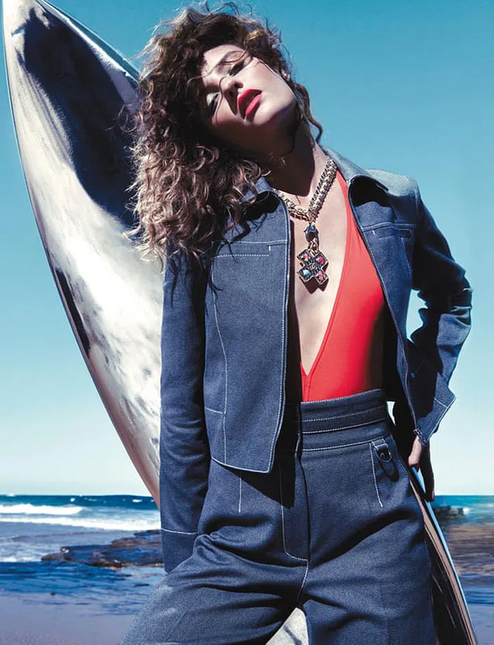 Denim jacket; denim pants. Lycra swimsuit, Eres. Metal and rhinestone medallion necklace, Chanel