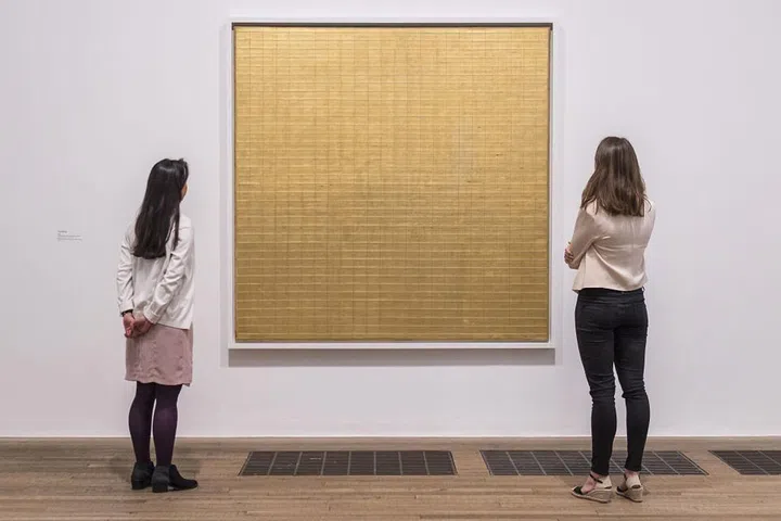 Agnes Martin, often associated with the minimalist movement, existed in a league of her own and defies easy categorization. Intensely private and spiritual, Martin explained that her paintings came to her fully formed, the size of postage-stamps, which she would translate onto large-scale canvases.  A glistening gold icon, Friendship from 1963 is fabulous example of a seminal grid painting by the artist.  Martin's delicately incised lines, seemingly perfect yet upon close inspection imbued with the sense of the human hand, produce an infinite field with a mysterious quality—the embodiment of a transcendent calm.  A retrospective of Martin's work opens at the Guggenheim in New York in October 2016. 
Pictured: Friendship on display at the Tate Modern in London in 2015
