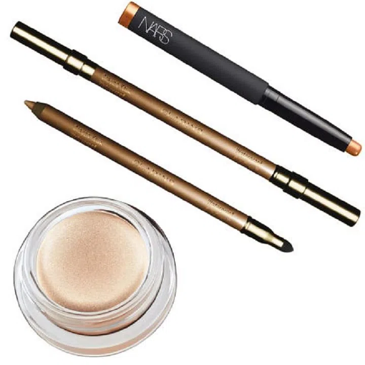 From left: Revlon ColorStay Crème Eye Shadow in Crème Brulee, $7, revlon.com; Clarins Eye Pencil in Gold, $27, clarins.com; Nars Velvet Shadow Stick in Belle-Île, $29, narscosmetics.com.