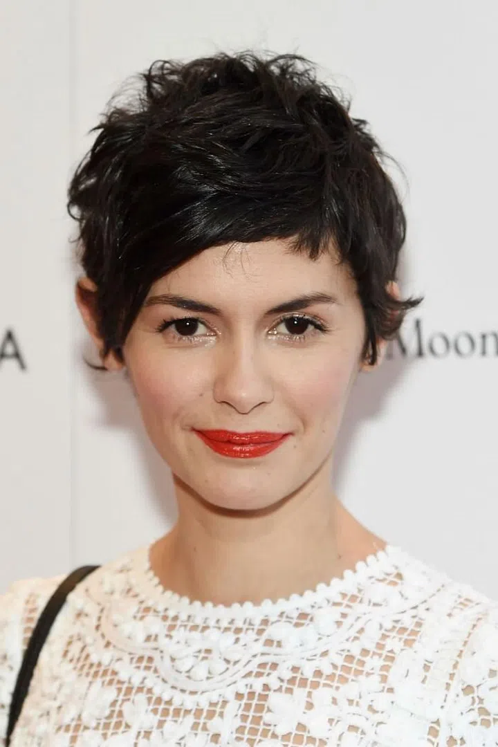 The flyaways here all look intentional, in a French trying-but-not-trying way. To embrace the natural bedhead look, casually flick some styling paste through your head and let the wind take over. Photo: Getty