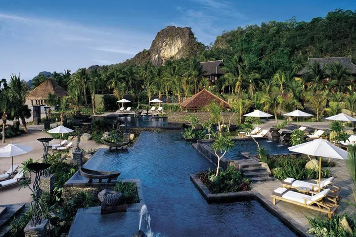 The resort sits on a mile-long stretch of beach on a small island in northwest Malaysia, bordering the Kilim-Karst Geoforest Park. One of the resort's biggest treats is an infinity pool that directly overlooks the ocean. Landscaped sections of the pool offer varying depths for all ages and it features waterfalls, fountains, and underwater jets.