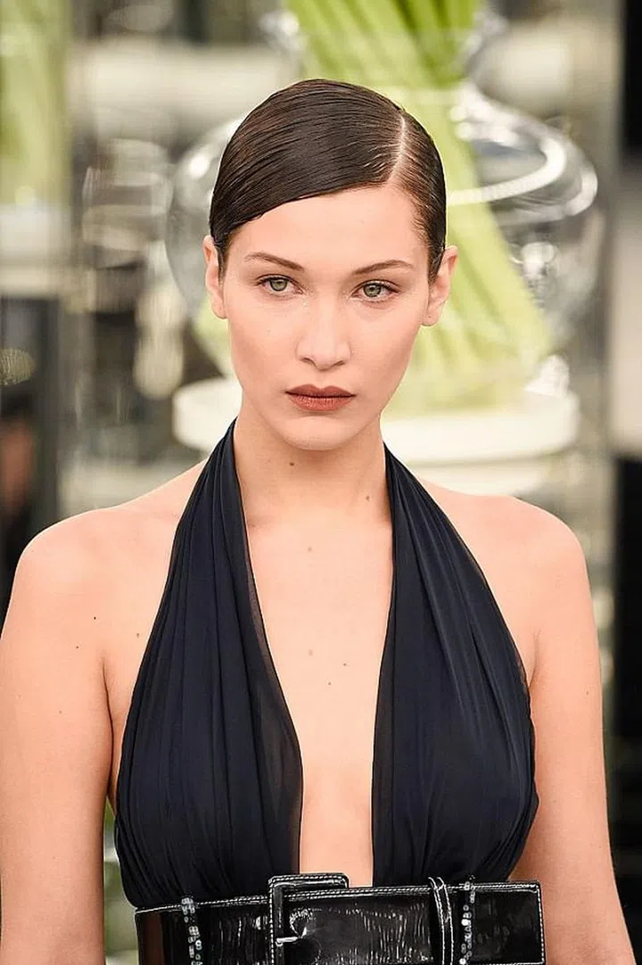 The understated combo of deep mauve lips and slick hair is a perfect match for the delicate pastels of the collection.

Photo: Getty Images