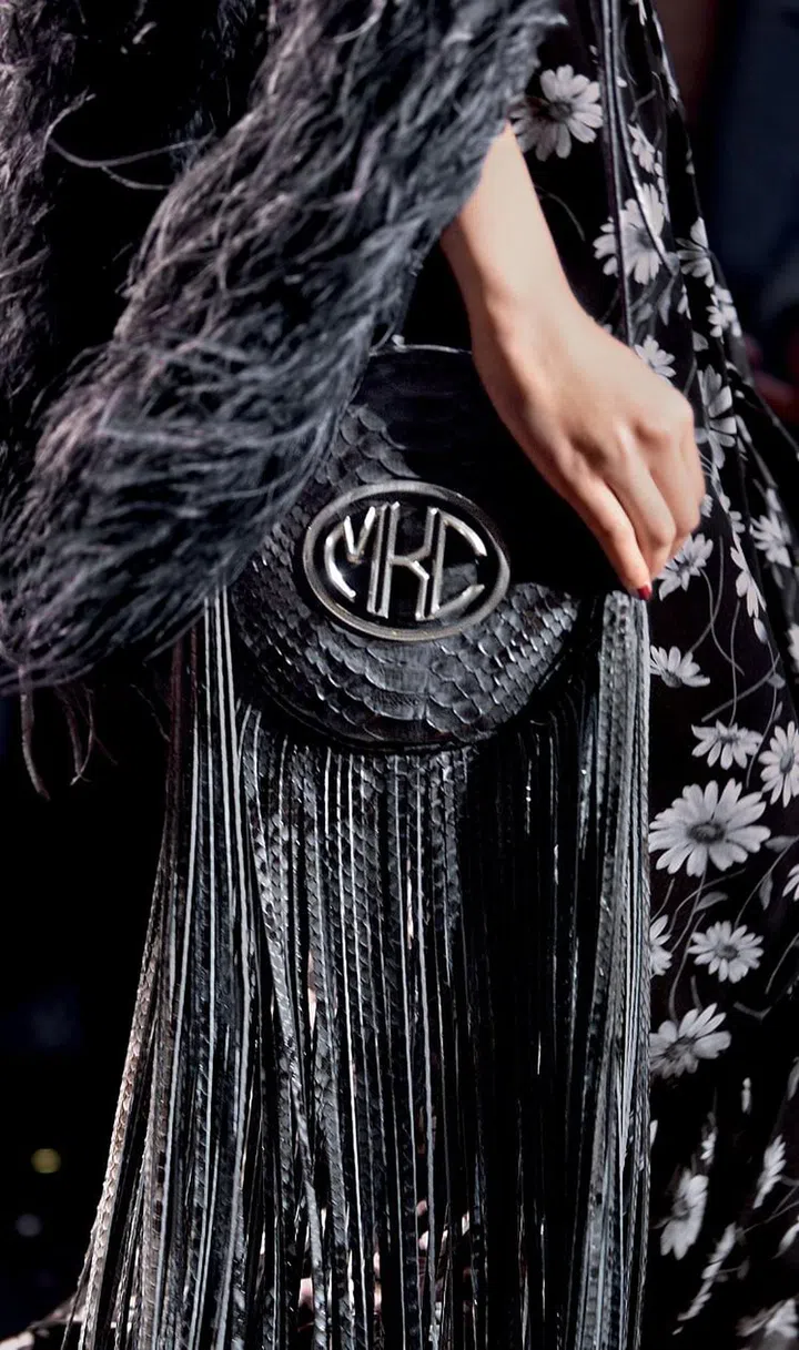 Now that the era of disco glamour is firmly back in the consciousness of pop
culture, Kors has decided to add to the conversation by revisiting his halcyon
days at Studio 54. He even secured the rights to the logos, which he embroidered onto sequinned t-shirt dresses, embellished on puffers and printed on silk blouses. The rest of the collection was an exuberant, extravagant
celebration of Studio 54 style at its most glittering, decadent height. There were
slinky slips, spangled dresses, feather trims, feather boas as well as lamé and
Lurex galore. Other period-specific details Kors resurrected included faux fur chubbies, fringed bags, towering platforms, turbans and berets.