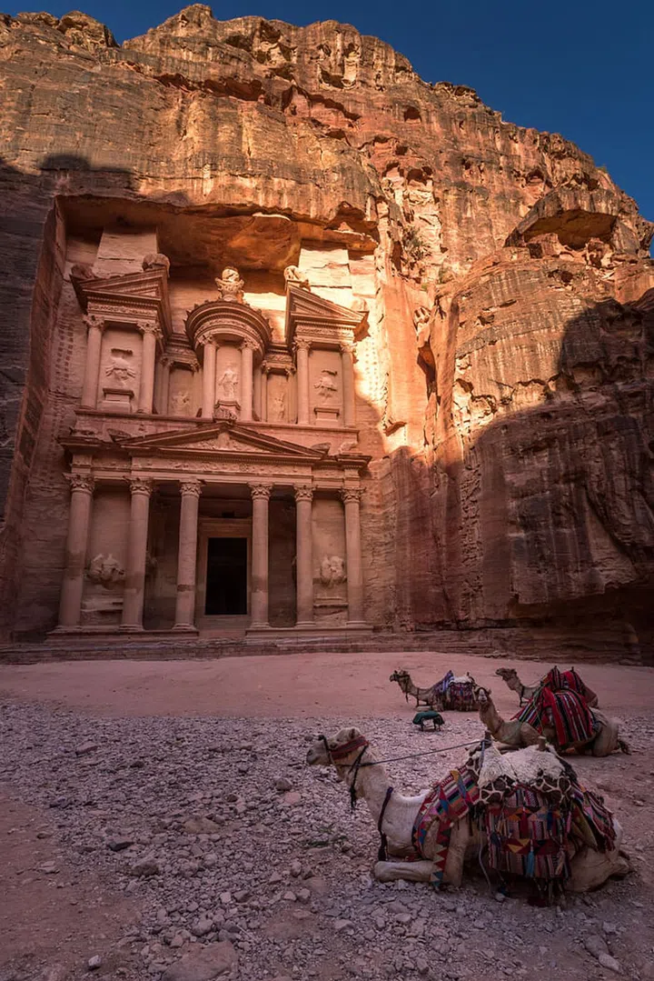 As one of the New Seven Wonders of the World, this pink sandstone city needs to be added to your bucket list ASAP. 

One of the most famous landmarks is the Treasury, a stone carved tomb featuring Hellenistic-style bas relief sculptures.

However, there's more to it than the Treasury.  Inside the complex, there are caves, a Roman theatre, more Royal Tombs and a monastery on top of the mountain.  

While the city is 264 square kilometers, the best way to explore it is with a donkey as the terrain is uneven. 

TIP: Don't forget to bring some water and food as there aren't many restaurants inside the site. 

Photo: Getty