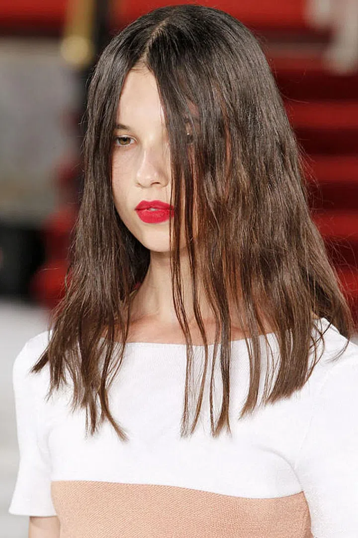  In the days before matte lipsticks were rolling around in the bags of basically every woman everywhere, makeup artists had to improvise. They powdered, blotted, and then re-powdered creamy lipsticks to create that velvety finish. It was this backstage trick that makeup artist Mark Carrasquillo recalled when he created the look at Creatures of the Wind. Except this time, the powder itself was the statement. After applying (and yes, blotting down) Nars Velvet Matte Lip Pencil in Dragon Girl, Carrasquillo dipped a fluffy brush in Nars blush in Exhibit A and dusted it all over the lips. Sweep after sweep, the electric fuchsia brought a dimension of color and texture to the lipstick impossible to achieve on its own. And other than making one hell of a statement, there's also this: you can rest assured knowing this lip look will not budge.