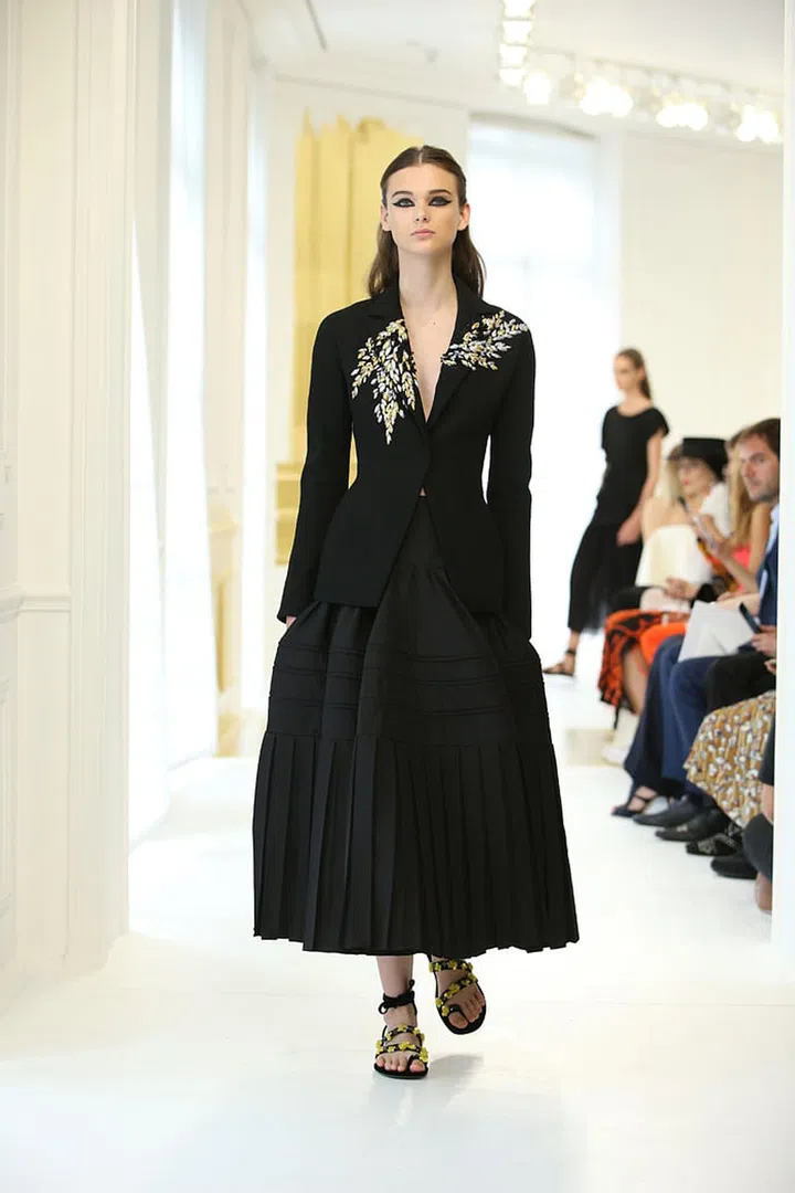 Black wool crêpe bar Jacket with gold and silver embroidery over a black silk faille skirt. Photo: Dior