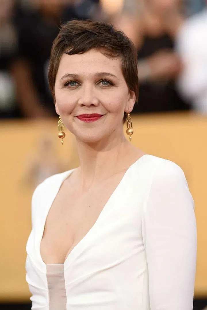 Naturally wavy hair + short angled bangs = pixie cut gold. Slick a tiny bit of paste into your fringe for some support (without the weight) and blow dry downwards then in the direction you want your fringe to land while drying your hair. Photo: Getty