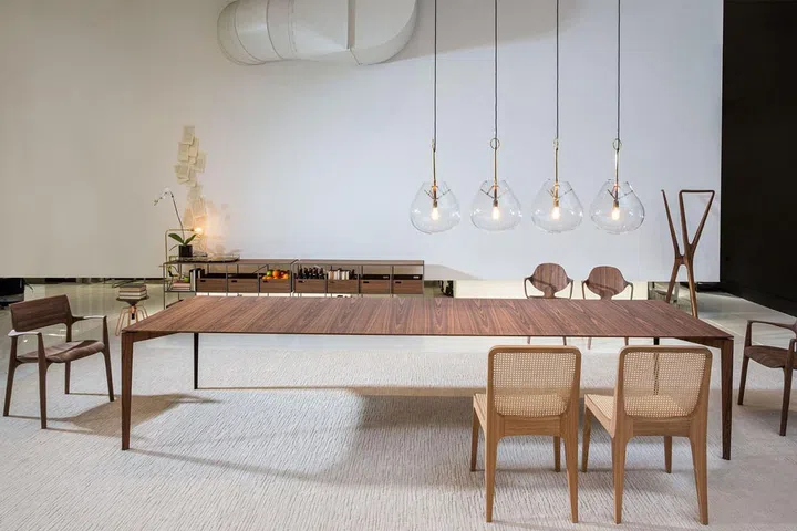 Aligning himself with Balenciaga, Jader Almeida chose wood pieces in sharp lines and hanging gold and glass ceiling lights for a look that showcases architectural shapes the Spanish fashion house loves.