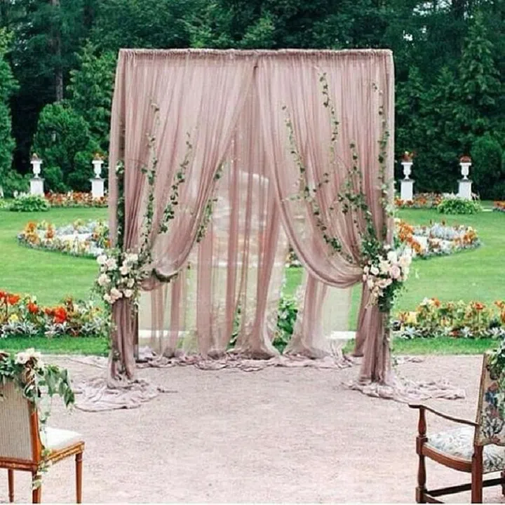 This shade of pink looks particularly romantic with greenery, like in this gorgeous ceremony backdrop. 