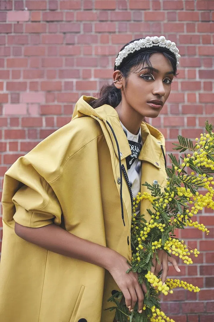 Headband, Simone Rocha x H&M. Coat; tunic, Prada. Earring, model’s own. (Photo: Phyllicia Wang)