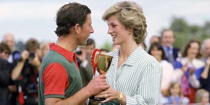 Holding a trophy together after his victory in a polo match. Photo: Getty 