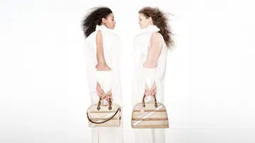 Models carrying Louis Vuitton Time Trunk Speedy and Alma bags.