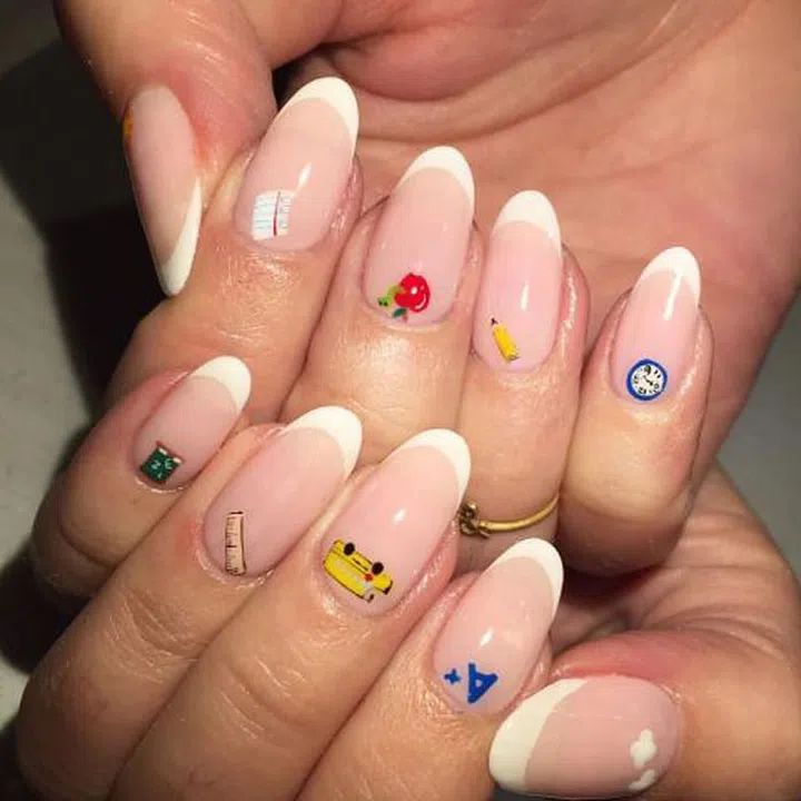 Bust out a thin brush to paint micro details to the base of your nail for a playful design. This back-to-school manicure by nail artist Kro Vargas features a yellow bus, a pencil, and a teeny tiny chalkboard. Design by @krocaine