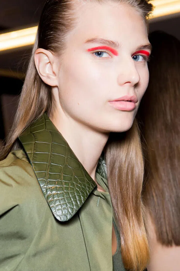 At Salvatore Ferragamo, the beauty look was focused on a bold stripe of orange-red eye makeup.