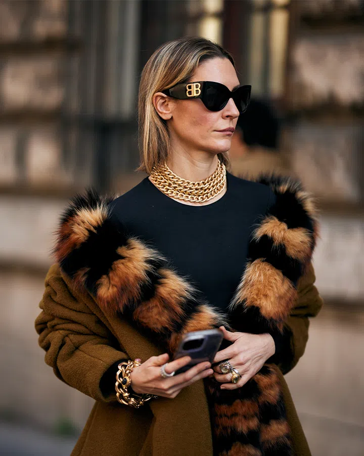 trends from the past watches and jewellery | a woman wearing rose gold jewellery during fashion week