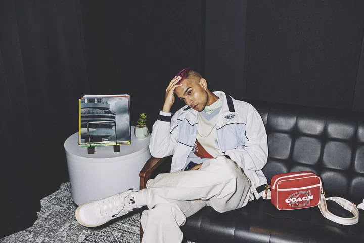 Colorblock Mashup Windbreaker $550; Horse Argyle Sweater $550; Graphic Ditsy Print Short Sleeve Shirt $215; Flight Bag $750; Citysole High Top Sneakers, $425. all by Coach. (Photo: Phyllicia Wang)