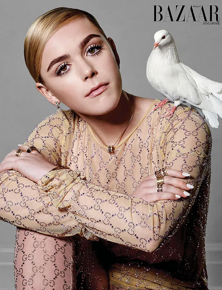 Dress; stockings, Gucci. Yellow gold and diamond B.zero1 Rock earrings; yellow gold and diamond B.zero1 Rock necklace; (on left hand, from left) yellow gold and diamond B.zero1 Rock four-band ring; rose gold B.zero1 four-band ring; yellow gold B.zero1 bangle bracelet; yellow gold and diamond B.zero1 Rebel bangle bracelet; rose gold B.zero1 bangle bracelet with logo; yellow gold B.zero1 bangle bracelet; (on right hand, from top) rose gold and ceramic B.zero1 Rock four-band ring; yellow gold and diamond B.zero1 Rock two-band ring; yellow gold B.zero1 four-band ring; rose gold and ceramic 
B.zero1 Rock two-band ring.
