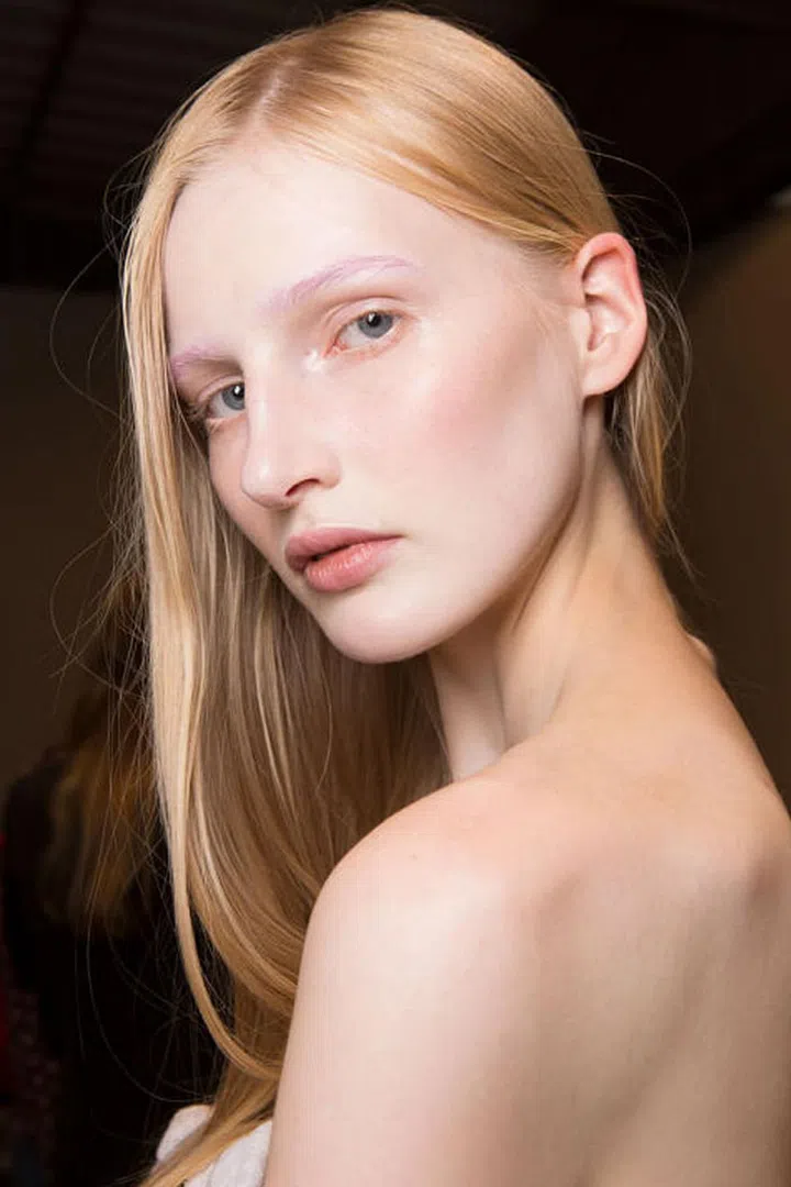 Eyebrows were dyed yellow and purple backstage at Gucci's spring 2017 show.