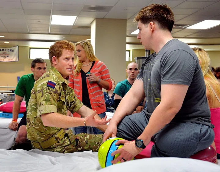 Prince Harry, 28, visits wounded U.S. veterans undergoing physical therapy in Bethesda, Maryland.