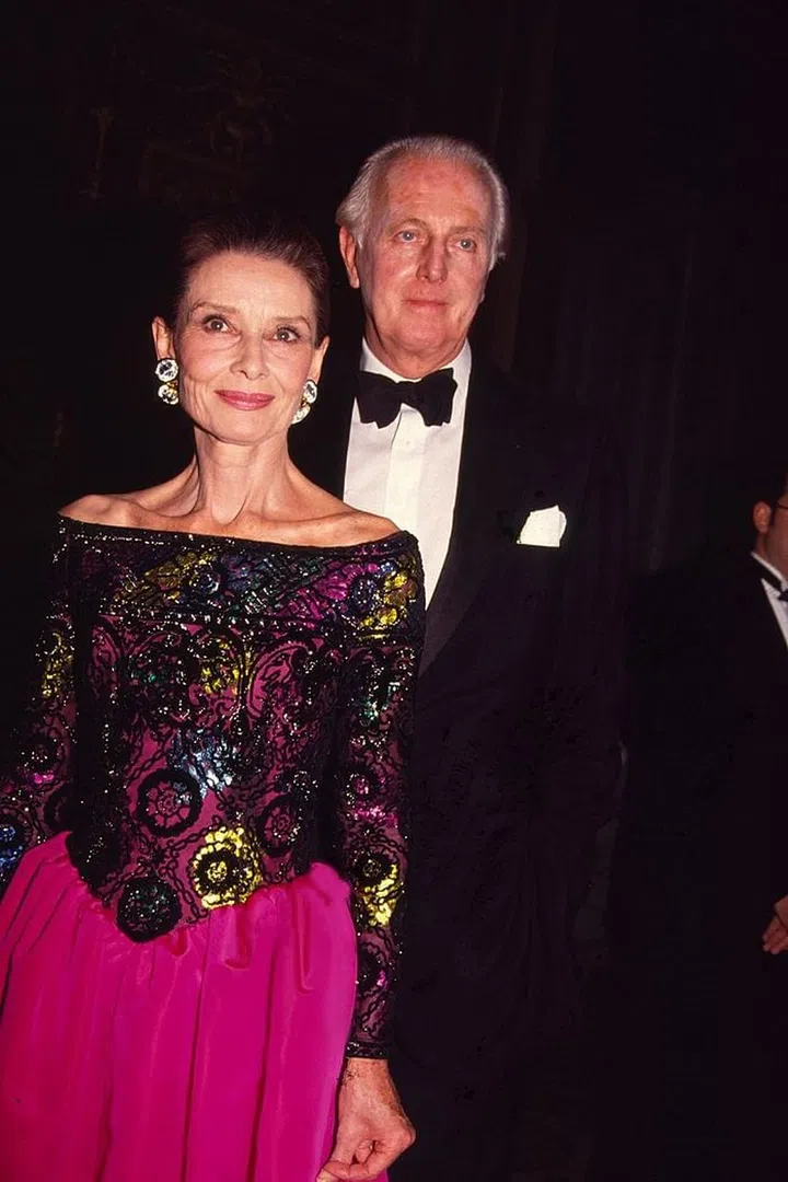 Hepburn wears a hot pink Givenchy ball gown alongside the designer at the 8th Annual Night of Stars Fashion Festival in New York.