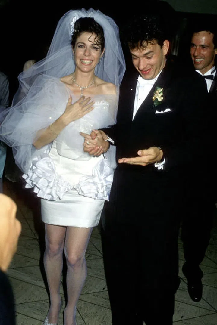 When Rita Wilson walked down the aisle with Tom Hanks, she rocked a super short, poofy-meets-bodycon dress that doesn't exactly stand the test of time. What did stand the test of time: their marriage. As of 2016, the couple has been together for 28 years — that's basically a century in celebrity relationship years.