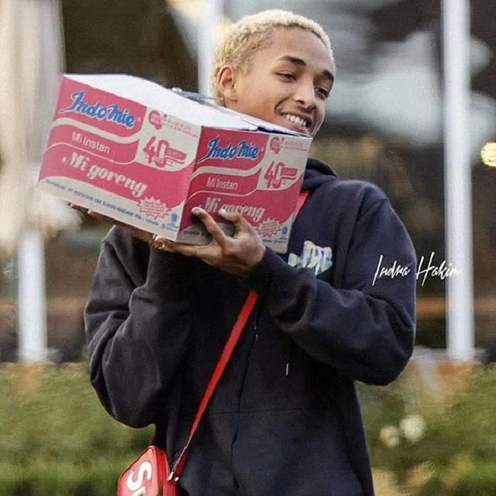 Jayden Smith carrying a box of Indo Mee. This is all part of The Smith's nutritious diet. 