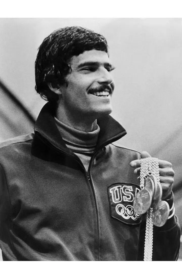 U.S. swimming champion Mark Spitz displaying a winning grin with five of his seven Olympic gold medals during the Munich Olympic Games. Photo: Getty