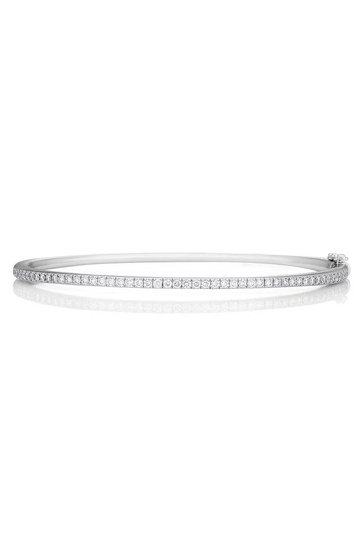 This slim De Beers bracelet is the perfect accessory for day and night with intricate pavé-diamond detailing.
