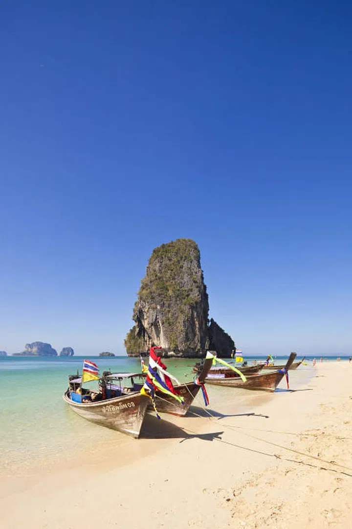 Cut off from the rest of the mainland of Krabi province by high limestone cliffs, Railay Beach is only accessible by boat, making it one of Thailand's most peaceful and beautiful beaches.