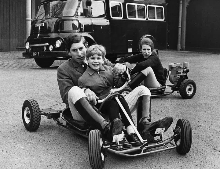 Prince Charles and Prince Edward ride in a go-kart while Princess Anne follows behind.
Photo: Getty