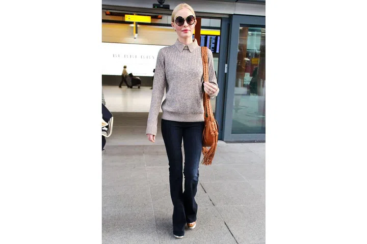 Kate Bosworth brings back the '70s prep look in this Trademark collared knit paired with her flared jeans and hobo bag ; Photo: Splash