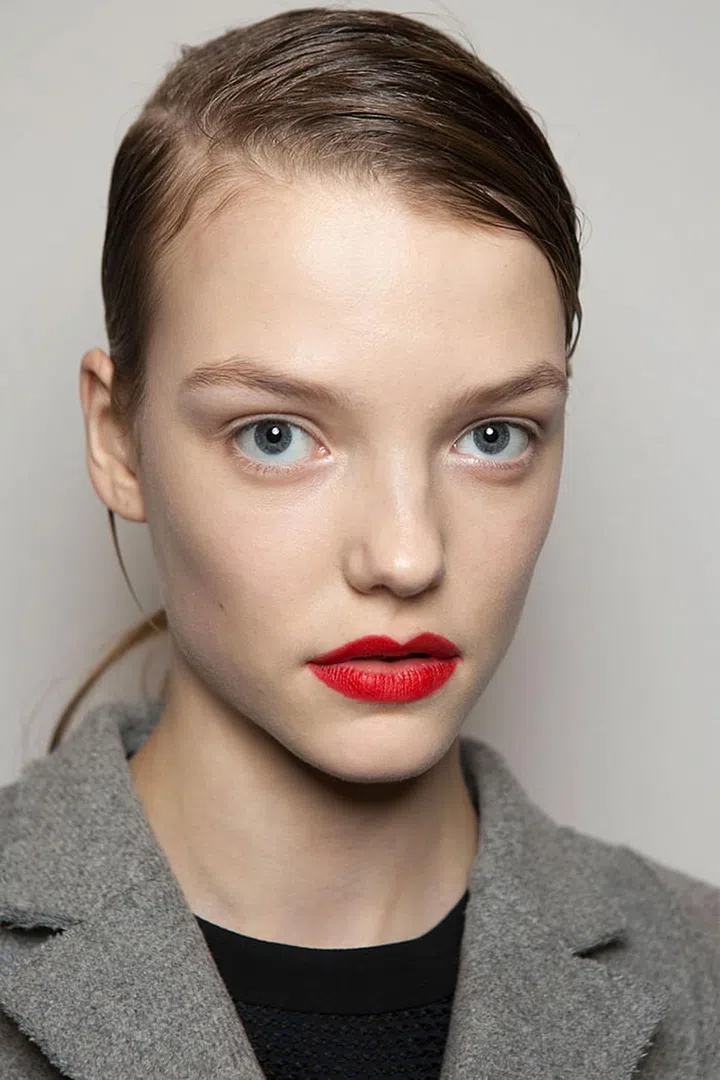 Pick up your candy apple red lipstick—the same one from Spring '16, how's that for getting your money's worth?—and dab it on with your fingers, or blot it off in the center with a tissue or apply it just slightly outside the corners. This is red lipstick for real women—the ones who don't own lip brushes, rarely get blowouts and just want to look a little cooler when they go from the gym to lunch. Photo: Imaxtree