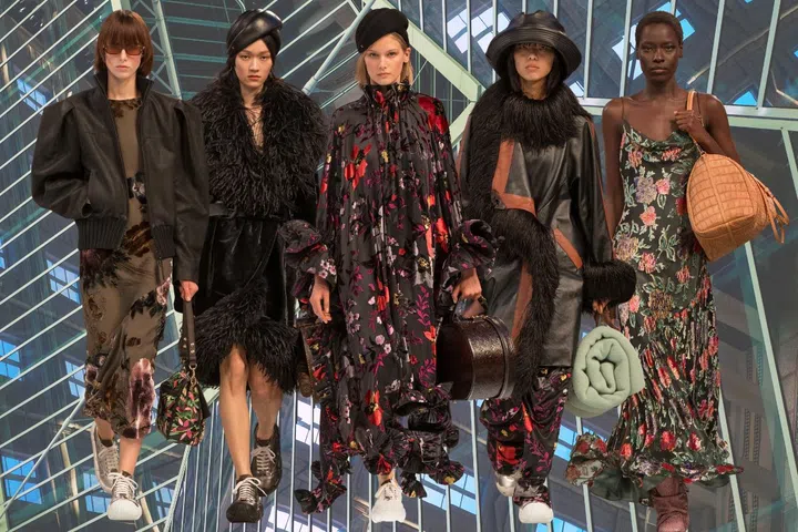 The ‘First Class’ passengers looks at the Louis Vuitton fall/winter 2025 show with the highlights on feather and Shibori silk technique on coats and dresses