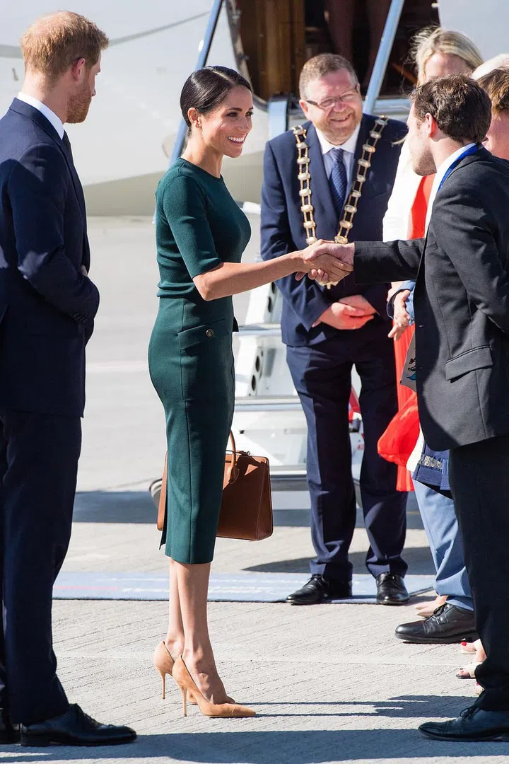 The couple greets their welcomers on the tarmac.

Photo: Getty