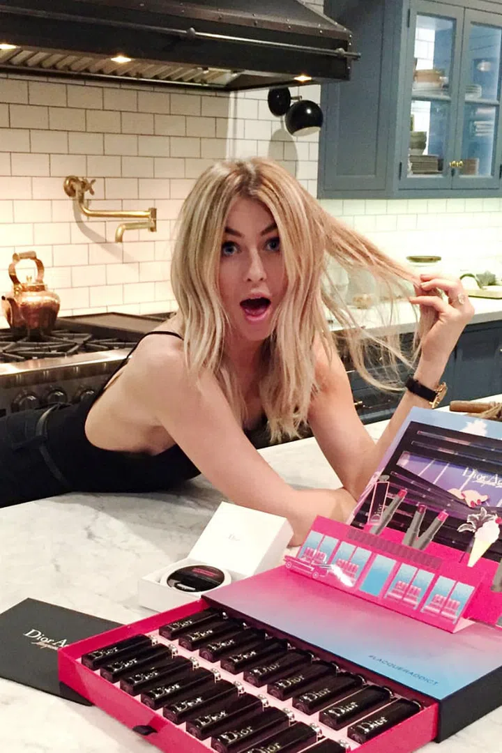 Choices, choices. Hough, at home in Los Angeles, poses with all 18 shades of the new Dior Addict Lacquer Stick collection before the launch event.
