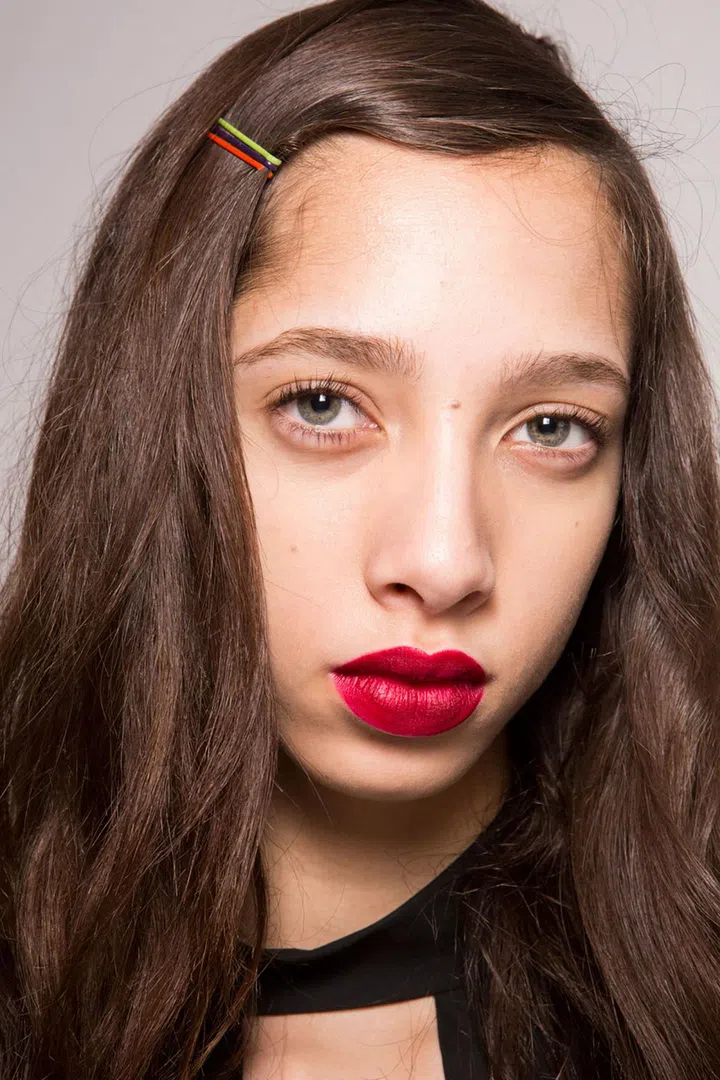 The models with long hair were given a low side-parting and two coloured hair slides, created by the hair stylist Sam McKnight.