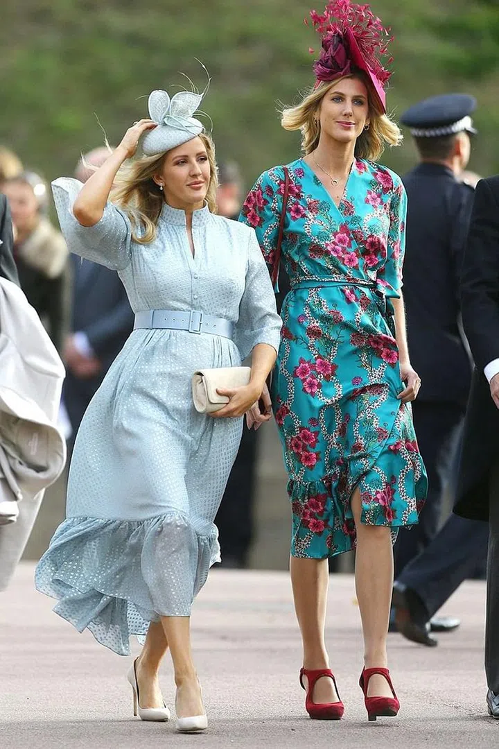 Singer Ellie Goulding keeping her fascinator from blowing away.