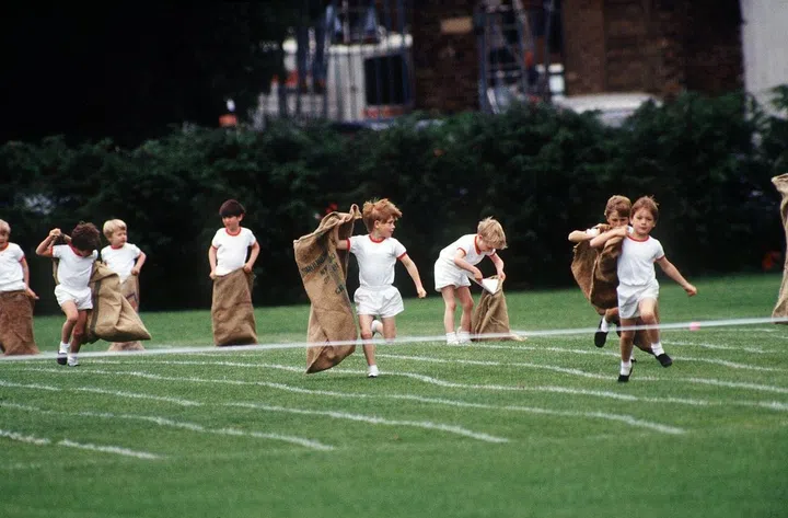 Prince Harry competes in a sack race at school.