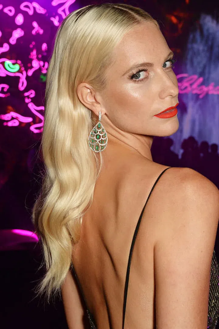 Delevingne plays up her glossy golden layers with evening-worthy polished waves. Photo: Getty
