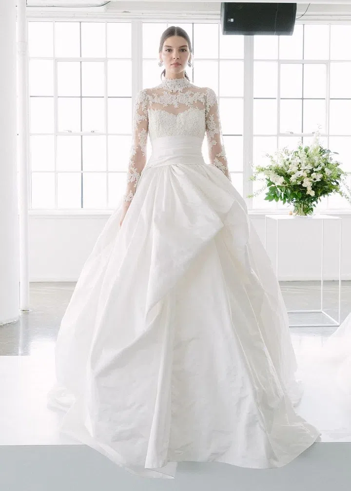 Marchesa's Georgina Chapman and Keren Craig may have had an inkling that Victorian necklines, full skirts and illusion lace were here to stay when they designed this stunning, regal look for their latest Spring 2018 collection. Brides looking for an over-the-top version of Pippa's gown should turn to them for a full skirt and majestic vibes.

Marchesa gown, price upon request, marchesa.com