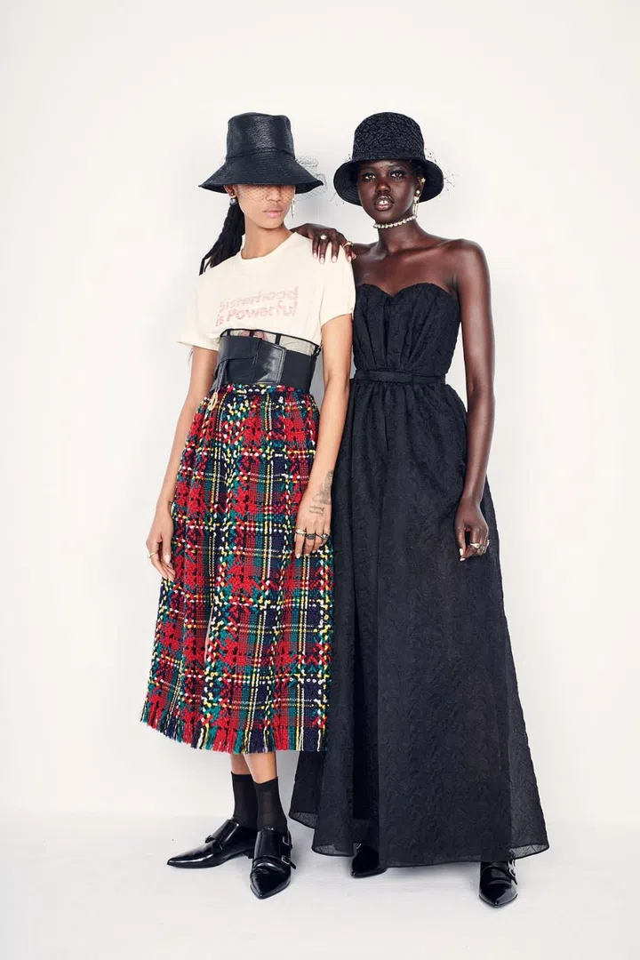 Women’s empowerment has become a key pillar of Maria Grazia Chiuri’s Dior. And she has pretty much established a formula for her ready-to-wear shows: She often works within the framework of a feminist message by an inspirational artist or author, with said message reiterated on a t-shirt, and complemented by lovely, ladylike clothes that are designed to be worn by real women with real-life needs. Hence, feminist artist Tomaso Binga’s seminal naked alphabet series lining the walls at her show and an opening look featuring the slogan “Sisterhood Is Global”, lifted from the title of activist Robin Morgan’s 1984 feminist anthology. The Dior woman continued to advance this cause in bodysuits, over which they threw soft Bar jackets or boxy buff alo-checked jackets, full skirts or sheer tulle, bustier tops or slim cashmere knits—all topped off by veiled bucket hats that marry the sporty with the sophisticated.