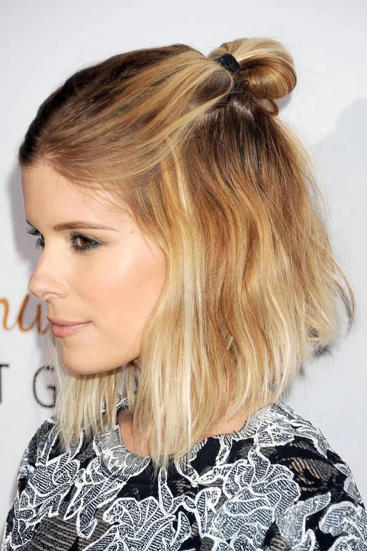 Kate Mara's tucked bun adds some rocker flair to her angled lob. Photo: Getty