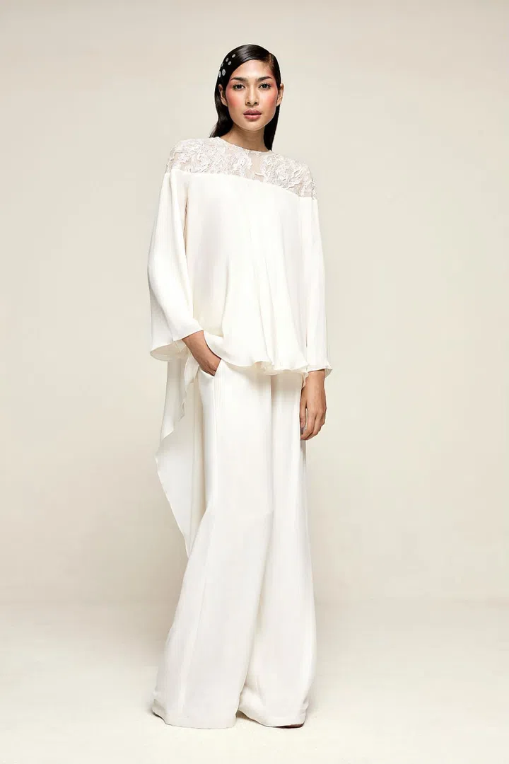 The cape-like details and the lace panel on this sophisticated top is great for bringing an ethereal flair to your getup. Photo: Society A