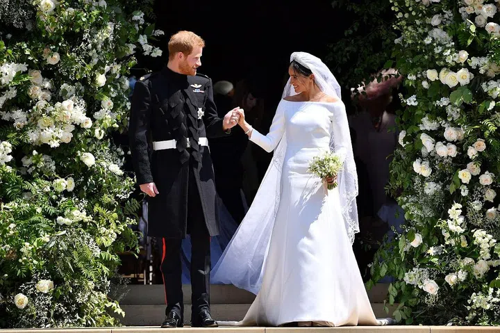 Prince Harry, Duke of Sussex and his wife Meghan, Duchess of Sussex emerge from the West Door of St George's Chapel