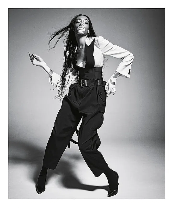 Givenchy jacket, pants, cummerbund, and belt’ Bulgari ring; Wolford stockings; Manolo Blahnik shoes