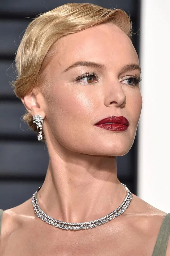 Kate Bosworth goes for an elevated updo with an sweeping wave that elegantly falls over one ear. Photo: Getty