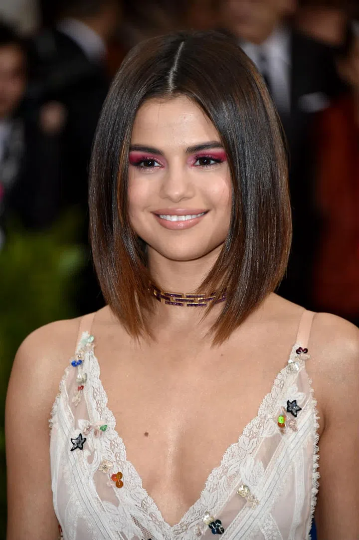 Gomez's centre parted bob and red metallic eye shadow brings Madonna's geisha-inspired "Nothing Really Matters" video to mind (Photo: Getty)