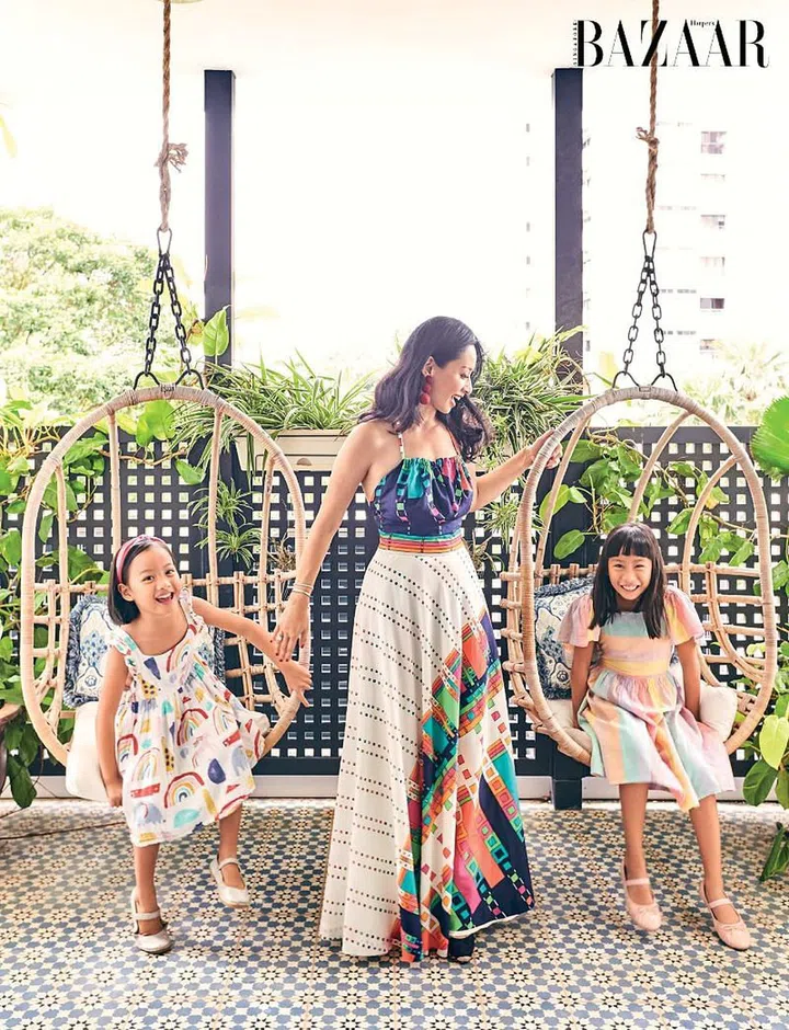 Long, in a vintage halter dress, Aquazzura wedges and Rebecca de Ravenel earrings, with her daughters Willow (left) and Sierra. 