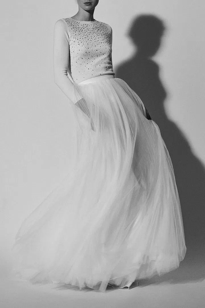 The concept of sporting a knit with a tulle skirt may seem outside the box, but we'd now consider it for any and all countryside affairs. The look is equal parts effortless and irreverent. Carolina Herrera Bridal Spring 2018 Look 6, carolinaherrera.com. 