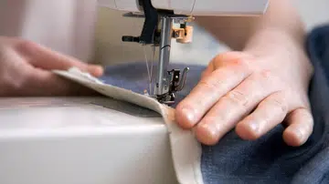 Close up of hands using a sewing machine
